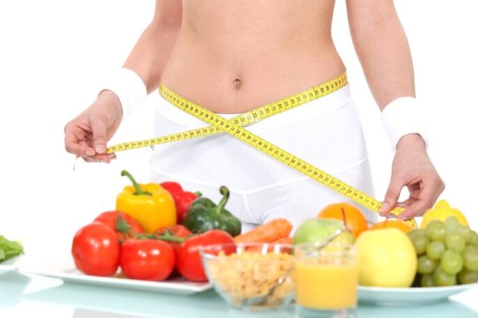 girl measuring waist against grocery store background